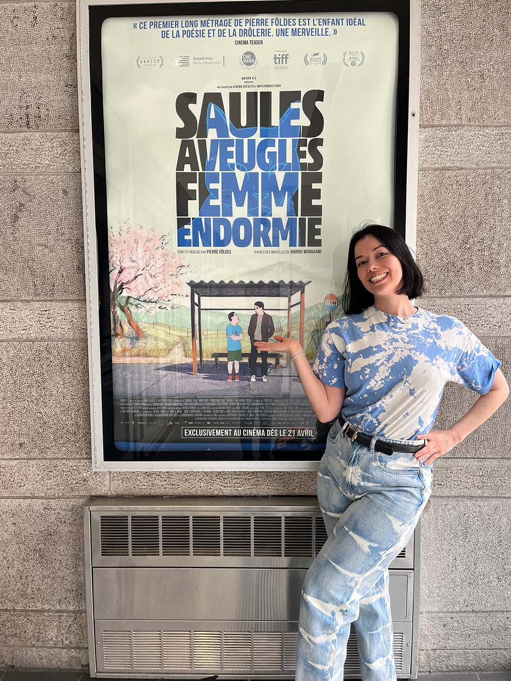 Cora Kim in front of the Blind Willow Sleeping Woman film poster, at the cinema in Montreal